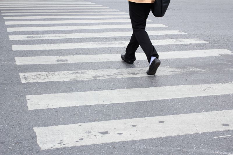 person crossing street at crosswalk