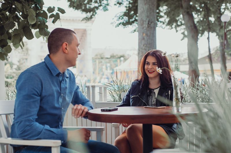 man and woman talking outside