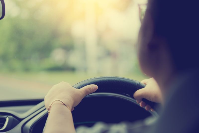 rear view of a woman driving a car