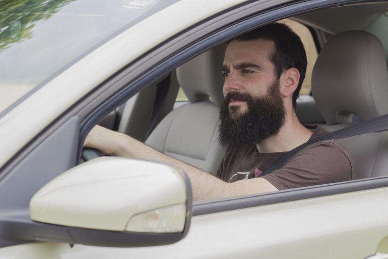driver looking perplexed behind the wheel