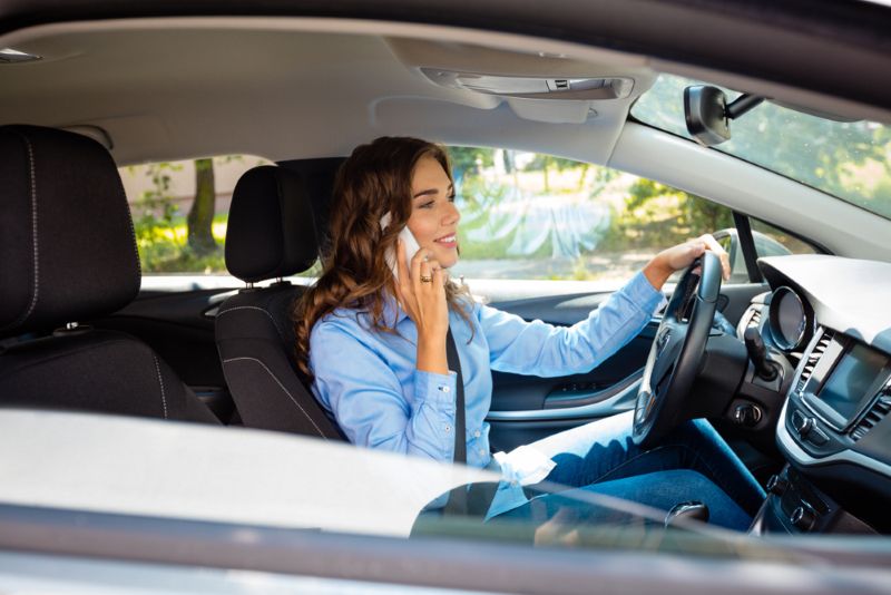 Woman driving while talking on her cell phone