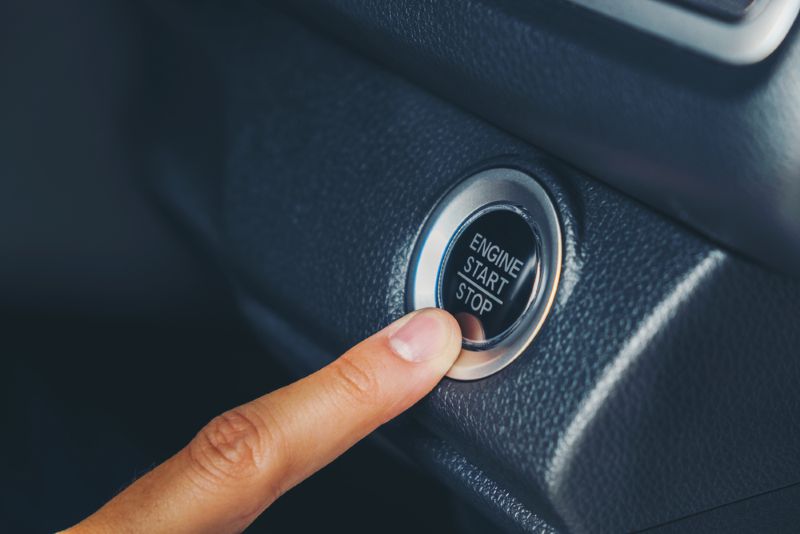 Closeup image of a person starting their car